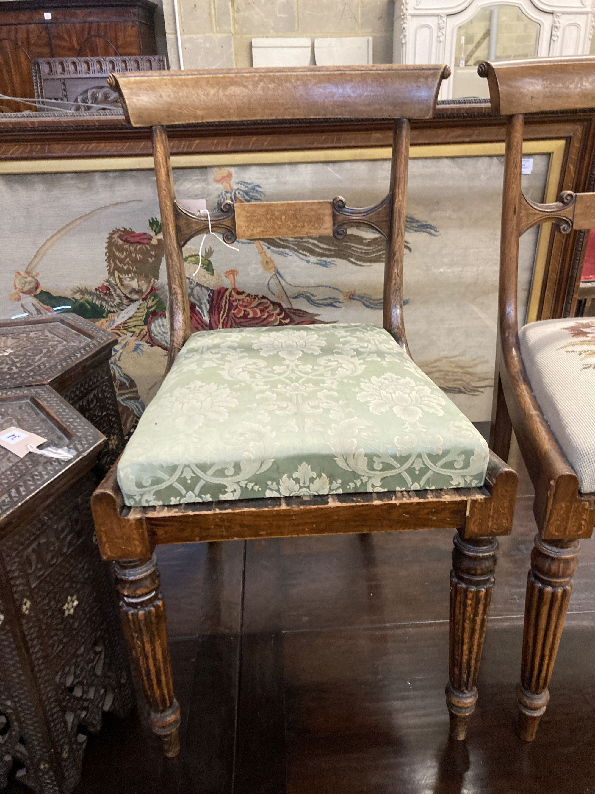 A pair of William IV simulated rosewood dining chairs, with curved marquetry inlaid crest rails and spars, over tapestry drop in seats